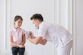 Brave girl receiving injection in arm in a hospital Royalty Free Stock Photo