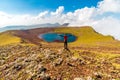 Man on a summit of Azhdahak volcano watching crater lake, Geghama mountains, Armenia