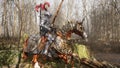 A brave medieval knight on his frisky horse prepares for battle. View of the fighting knight and his horse rearing up Royalty Free Stock Photo