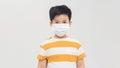 Brave teen boy with medical mask standing with courageous face isolated on white. Childhood, stylish kids, fighting covid-19