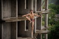 Brave topless man walking on a slackline on rainy day