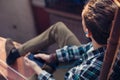 Brave traveler sitting on edge of the roof and listening music Royalty Free Stock Photo