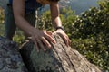 backpacker climbing rock to the mountain top Royalty Free Stock Photo