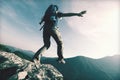 Brave woman hiker walking to the cliff edge