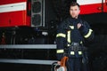 Brave young fireman wearing protective uniform.