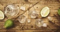 Braziilian vodka cachaca in shot glasses with lime on wooden table, iced strong alcohol drink in misted glass. Top view, negative Royalty Free Stock Photo