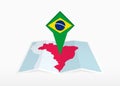 Brazil is depicted on a folded paper map and pinned location marker with flag of Brazil Royalty Free Stock Photo