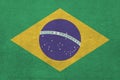 Brazil flag depicted in bright paint colors on old relief plastering wall. Textured banner on rough background Royalty Free Stock Photo