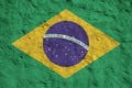 Brazil flag depicted in bright paint colors on old relief plastering wall. Textured banner on rough background Royalty Free Stock Photo