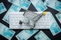 Brazilian money, White computer keyboard, Miniature shopping cart, Black background, Online shopping concept in stores, Low prices Royalty Free Stock Photo