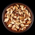 Brazil nut in a plate black background Royalty Free Stock Photo