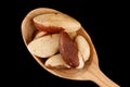 Brazil nut in a wooden spoon black background Royalty Free Stock Photo