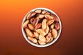 Brazil nuts in bowl top view with colored gradient background Royalty Free Stock Photo