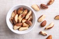 Brazil nuts, dried seeds in a white bowl on linen fabric Royalty Free Stock Photo