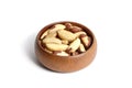 Brazil nuts in wooden bowl isolated on white. Peeled brazil nuts Royalty Free Stock Photo