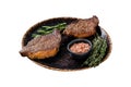 Brazilian BBQ - grilled dry aged picanha beef steak with herbs. Isolated on white background. Top view.