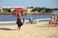 Brazilian beach vendor selling bikini at Copacabana beach