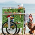 A Brazilian beach vendor selling boiled corn wheels a cart of hot water along Ipanema