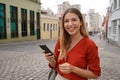 Brazilian business woman holding mobile phone looks at camera in Curitiba, Brazil Royalty Free Stock Photo