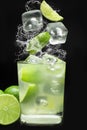 Brazilian caipirinha splash in black background Royalty Free Stock Photo