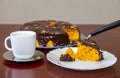 Brazilian carrot cake with chocolate icing decorated with slices of fresh carrots in selective focus