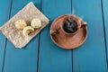 Brazilian cheese breads next to coffee cup and golden spoon_top view