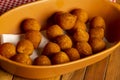 Brazilian chiken snack in ceramic container on wooden table