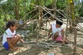 Brazilian children playfully learn to build a hut