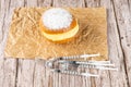 Brazilian cream donuts on brown paper, next to several syringes and ampoules of insulin