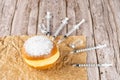 Brazilian cream donuts on a brown paper and surrounded by several syringes and ampoules of insulin
