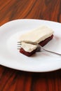 Brazilian dessert, guava paste and white chesse with fork on the white plate.