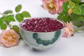 Brazilian dessert made of tapioca pearls called sagu in red wine flavor in a bowl with roses in the background Royalty Free Stock Photo