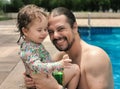 Brazilian Father and Daughter having fun at swimming pool