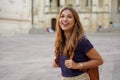 Brazilian female tourist laughing outdoors. Beautiful traveler girl joyful on her jouney in Europe