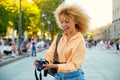 Brazilian female tourist looking at photos in her camera in Madrid, Spain.