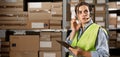 brazilian female worker in headset at logistics warehouse using digital tablet. speaks into a microphone against the Royalty Free Stock Photo