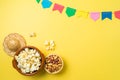 Brazilian Festa Junina party background with popcorn, peanuts and colorful banners. Top view from above