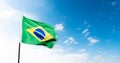 Brazilian flag waving against blue sky Royalty Free Stock Photo