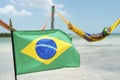 Brazilian Flag Waving in front of Beach Hammocks Royalty Free Stock Photo