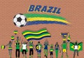 Brazilian football fans cheering with Brazil flag colors in front of soccer ball graffiti Royalty Free Stock Photo