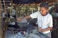 Brazilian girl is cooking on a wood fire with firewood