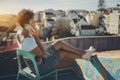 Brazilian girl phoning on roof in Lisbon