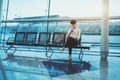 Brazilian girl sitting in railway station depot with smartphone Royalty Free Stock Photo