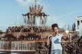 Brazilian girl is taking selfie next to fountain using cellphone Royalty Free Stock Photo