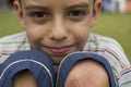 Brazilian kid outdoors with wound on knee