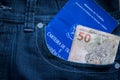 Brazilian labor portfolio and fifty reais bills in jeans pocket