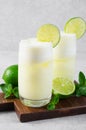 Brazilian Lemonade, Refreshing Creamy Lemonade or Limeade with Lime Slices and Mint on Grey Background