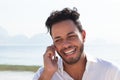 Brazilian man at Copacabana beach talking at phone Royalty Free Stock Photo