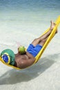 Brazilian Man Relaxing in Beach Hammock with Drinking Coconut Royalty Free Stock Photo