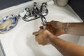 Brazilian man washing his hands